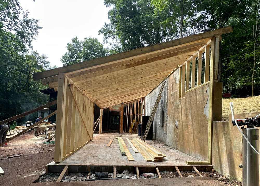 Framing work with wood beams and support studs being installed