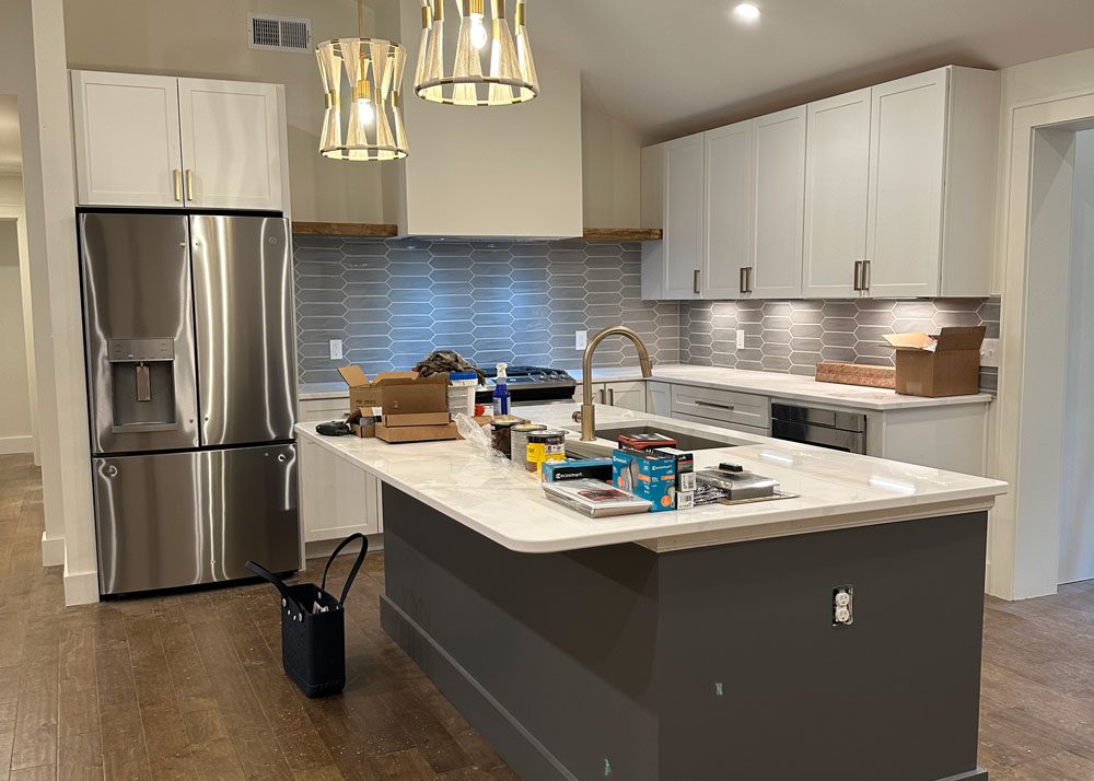 Kitchen remodel with gray cabinets, built-in storage, and a marble tile floor