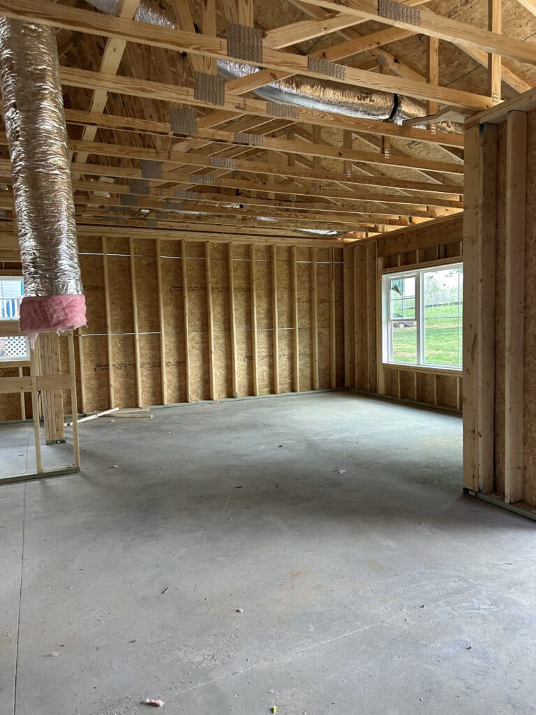 Close view of vaulted ceiling truss framing and HVAC ductwork rough-in inside a custom new construction home by Blalock and Murray General Contractors in Maryville TN